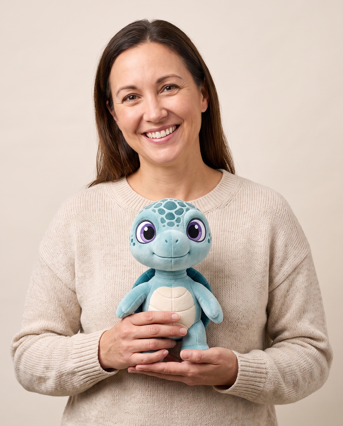A woman holding the Eli plush against her chest